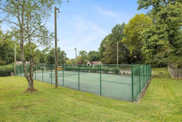 view of tennis court with a lawn