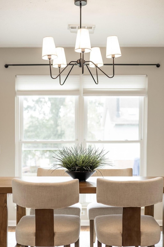 unfurnished dining area with plenty of natural light and an inviting chandelier