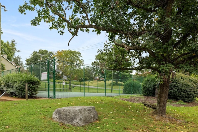 view of sport court with a lawn and tennis court