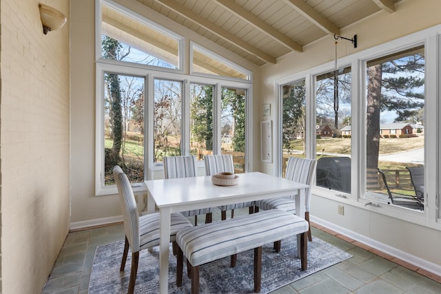 sunroom featuring lofted ceiling with beams and wooden ceiling