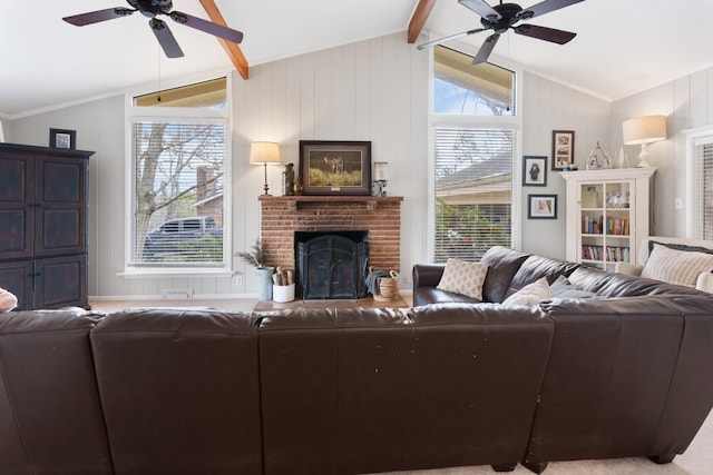 living room featuring lofted ceiling with beams, a brick fireplace, and ceiling fan