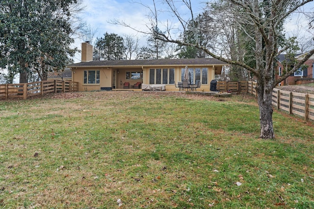 rear view of house featuring a patio and a lawn