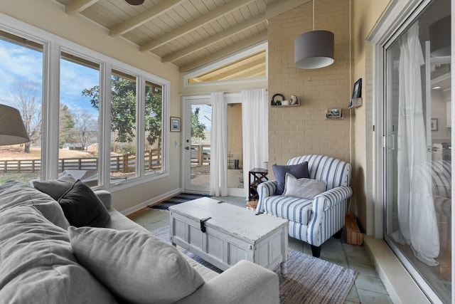 sunroom featuring lofted ceiling with beams and wooden ceiling