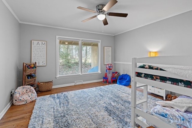 bedroom featuring wood-type flooring, ceiling fan, and crown molding