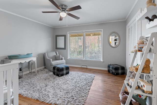 bedroom featuring hardwood / wood-style floors, ceiling fan, and ornamental molding