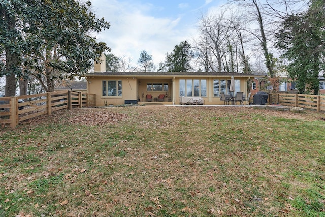 back of property featuring a yard and a patio