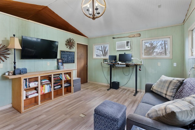 living room with a wall mounted air conditioner, a notable chandelier, light wood-type flooring, and lofted ceiling