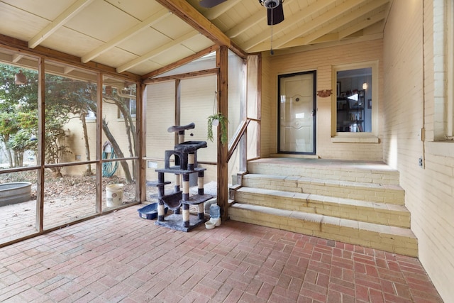 unfurnished sunroom featuring lofted ceiling with beams and ceiling fan