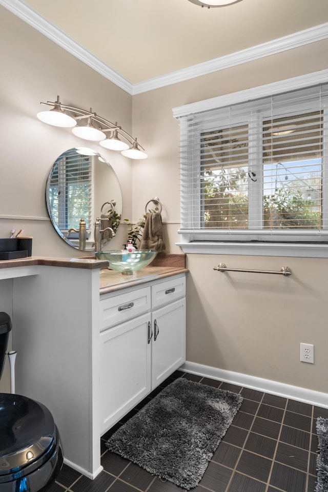 bathroom with crown molding, tile patterned flooring, and vanity