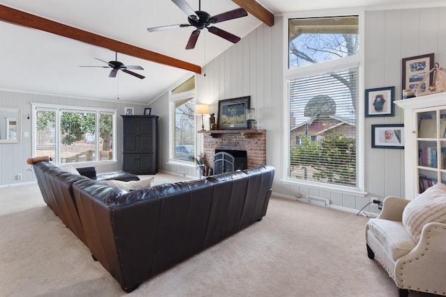 carpeted living room featuring lofted ceiling with beams, ceiling fan, and a fireplace