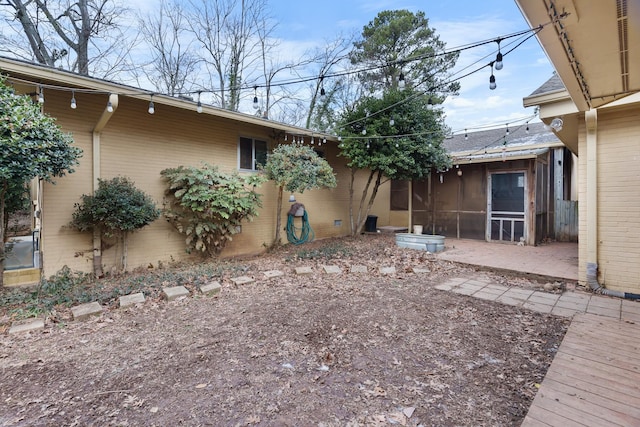 rear view of house featuring a patio area and a sunroom