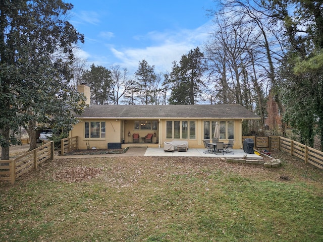 back of property featuring a patio area and a yard