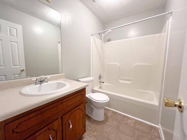 bathroom with toilet, tub / shower combination, a textured ceiling, vanity, and tile patterned flooring