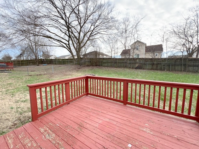 wooden deck with a fenced backyard and a lawn