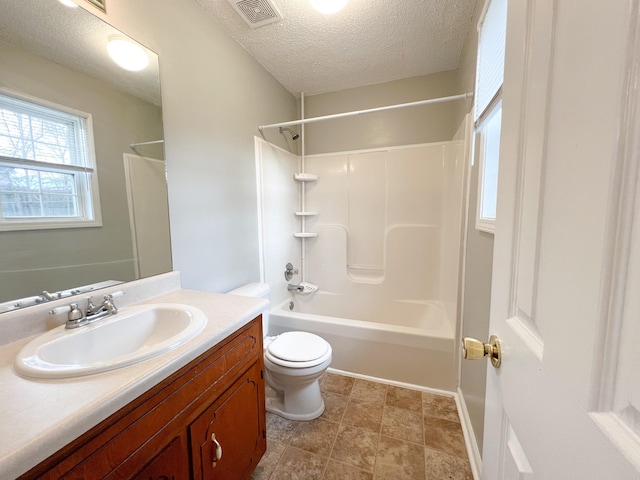 bathroom featuring visible vents, vanity, toilet, and a textured ceiling