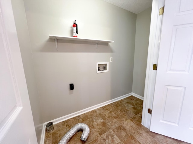 laundry room with hookup for a washing machine, hookup for an electric dryer, a textured ceiling, laundry area, and baseboards