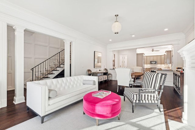 living room featuring dark hardwood / wood-style flooring and crown molding