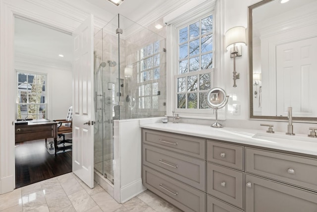 bathroom with a shower with door, crown molding, and vanity