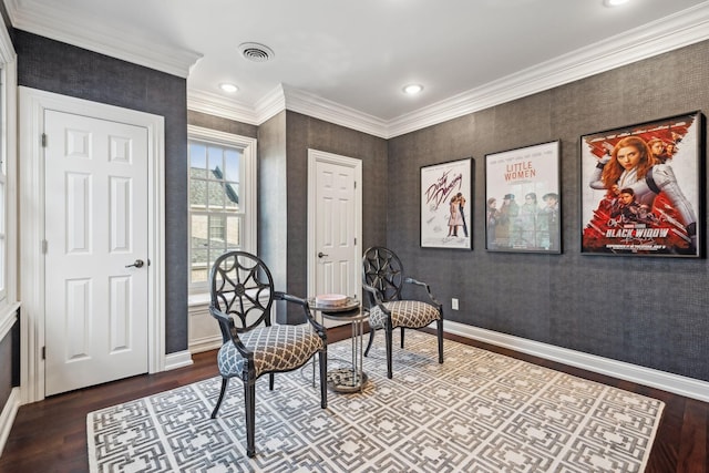 living area with wood-type flooring and ornamental molding