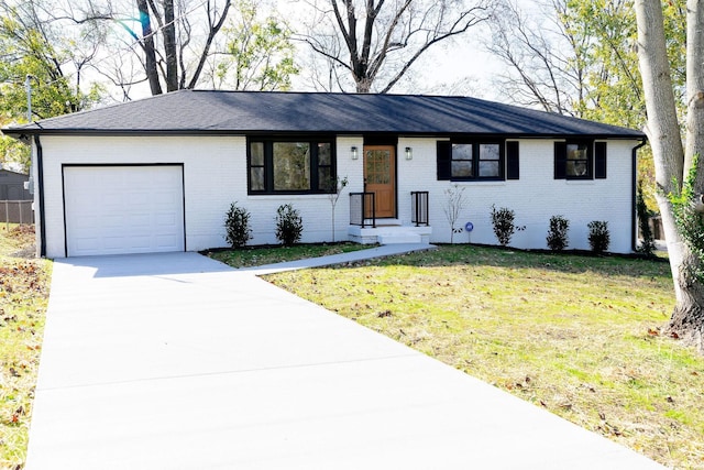 single story home featuring a garage and a front yard