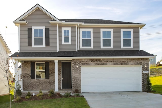 view of front of home with a garage and a front lawn