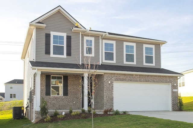 view of front of home with a garage, central air condition unit, and a front lawn