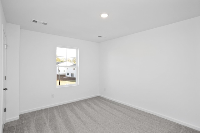 unfurnished room featuring light carpet