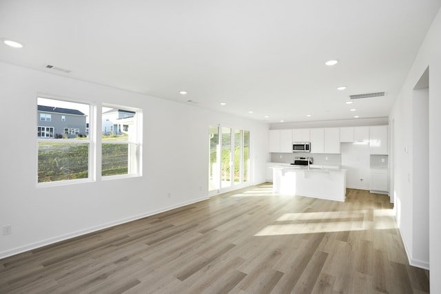 unfurnished living room with light hardwood / wood-style floors