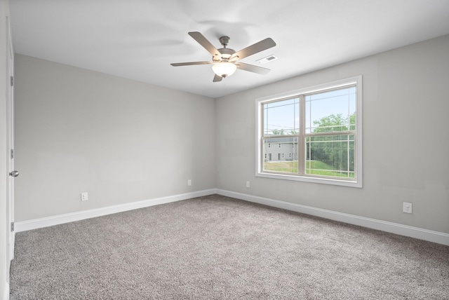 carpeted spare room with ceiling fan