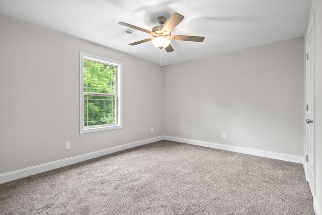 empty room with ceiling fan and carpet floors