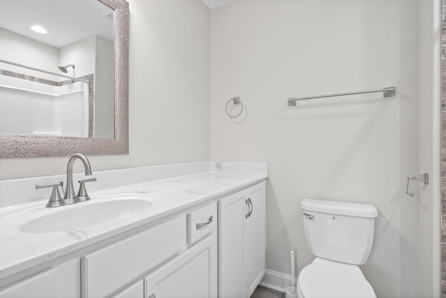 bathroom featuring vanity, toilet, and walk in shower