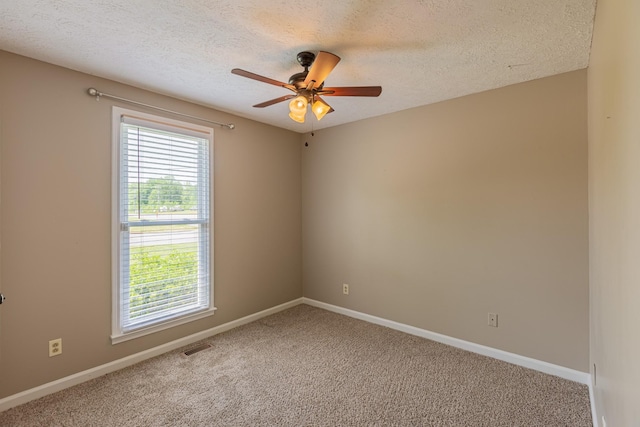 carpeted empty room featuring a textured ceiling and ceiling fan