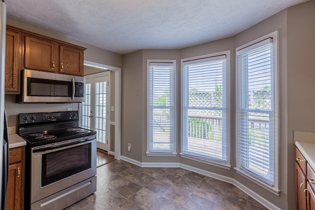 kitchen featuring a textured ceiling and appliances with stainless steel finishes