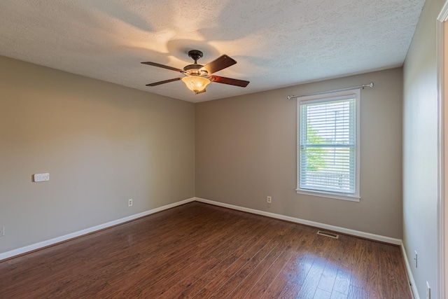 unfurnished room with a textured ceiling, ceiling fan, and dark hardwood / wood-style floors