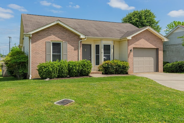 ranch-style home with a front yard and a garage