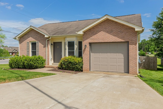 single story home featuring a front lawn and a garage