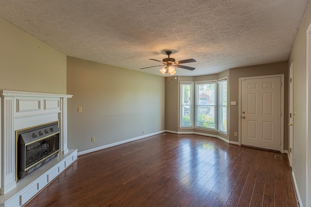 unfurnished living room with a textured ceiling, ceiling fan, and dark hardwood / wood-style flooring