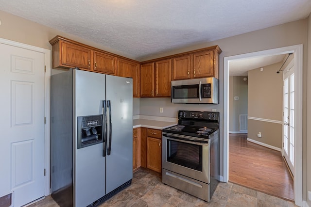 kitchen featuring a textured ceiling and appliances with stainless steel finishes