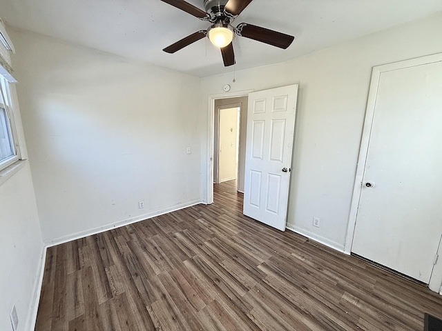 unfurnished bedroom with ceiling fan and dark hardwood / wood-style flooring