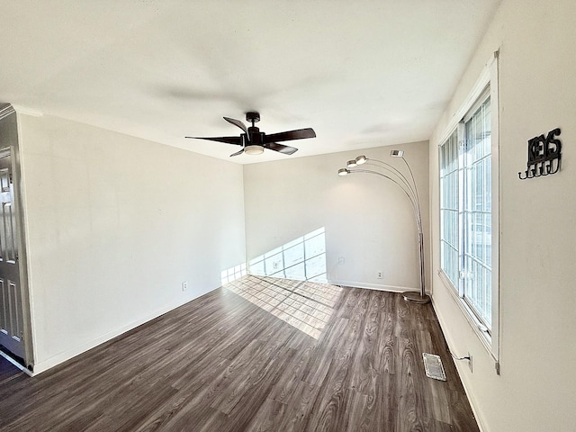 unfurnished living room with ceiling fan and dark hardwood / wood-style flooring