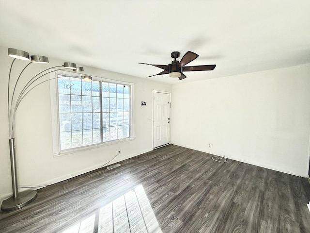 unfurnished room featuring dark hardwood / wood-style flooring and ceiling fan