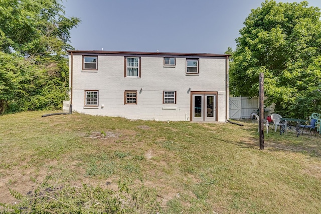 rear view of property with a lawn