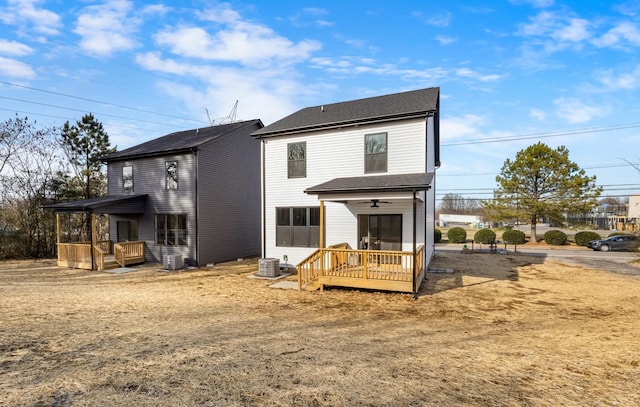 rear view of house featuring a wooden deck and central air condition unit