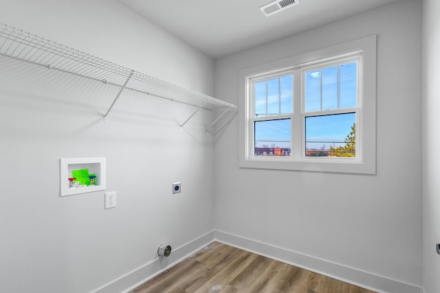 laundry area with wood-type flooring, hookup for an electric dryer, and hookup for a washing machine