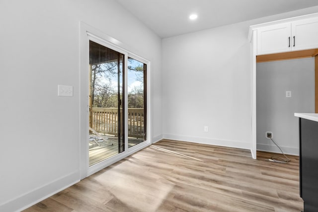 unfurnished dining area featuring light wood-type flooring