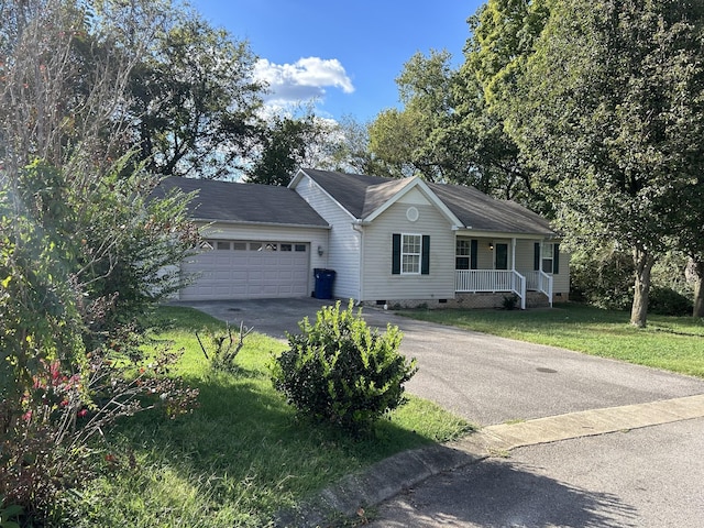 single story home with covered porch, a front lawn, and a garage