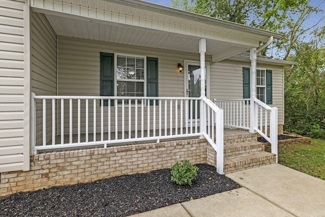 view of exterior entry featuring a porch