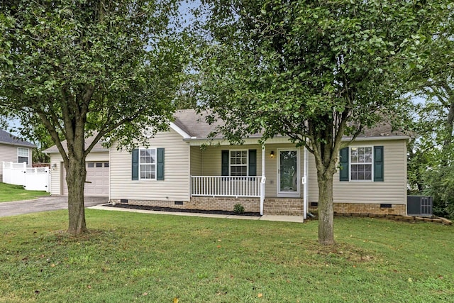 view of front of home with cooling unit, a front yard, covered porch, and a garage