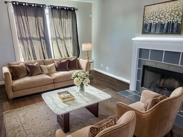 living room with dark wood-style floors, a fireplace, and baseboards