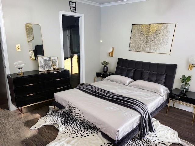 bedroom with ornamental molding and dark wood-type flooring